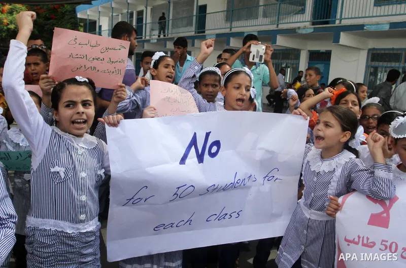 Palestinian pupils take part in a protest against the reduction of educational programs given by the United Nations Relief and Works Agency (UNRWA) and the growing number of students per class due to lack of funds in the...