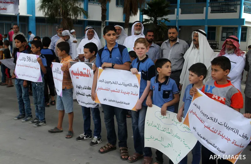 Palestinian pupils take part in a protest against the reduction of educational programs given by the United Nations Relief and Works Agency (UNRWA) and the growing number of students per class due to lack of funds in the...