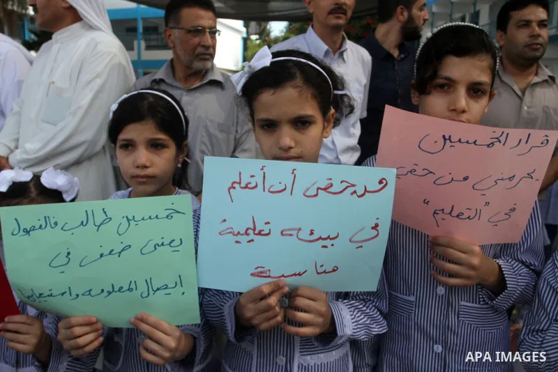Palestinian pupils take part in a protest against the reduction of educational programs given by the United Nations Relief and Works Agency (UNRWA) and the growing number of students per class due to lack of funds in the...