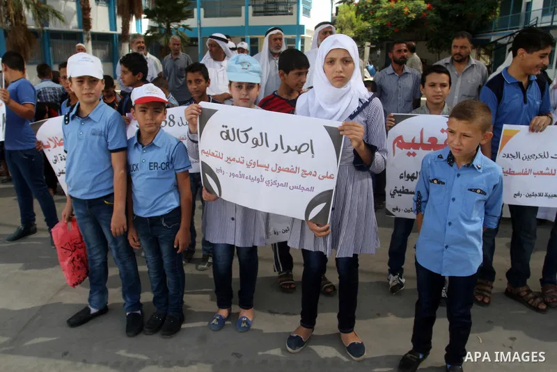 Palestinian pupils take part in a protest against the reduction of educational programs given by the United Nations Relief and Works Agency (UNRWA) and the growing number of students per class due to lack of funds in the...