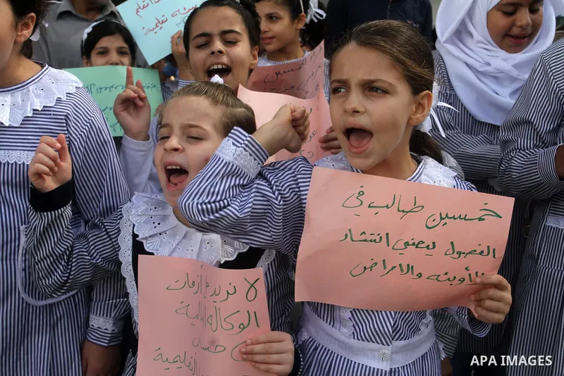 Palestinian pupils take part in a protest against the reduction of educational programs given by the United Nations Relief and Works Agency (UNRWA) and the growing number of students per class due to lack of funds in the...