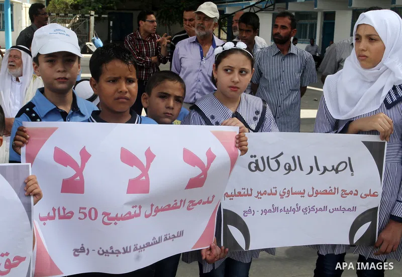 Palestinian pupils take part in a protest against the reduction of educational programs given by the United Nations Relief and Works Agency (UNRWA) and the growing number of students per class due to lack of funds in the...
