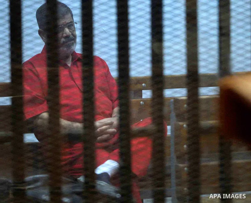 Ousted Egyptian president Mohammed Morsi sits behind bars during his trail in a court in Cairo on August 30, 2015. Cairo criminal court resumes today the trial of deposed president Mohamed Morsi and 10 others on charges...