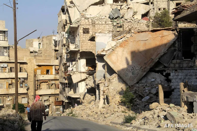 A Syrian man walks past the rubble of buildings which destroyed by forces of Syria's President Bashar al-Assad, in a rebel-controlled area in the northern Syrian city of Aleppo, on August 31, 2015. Photo by Ameer al-Halb...