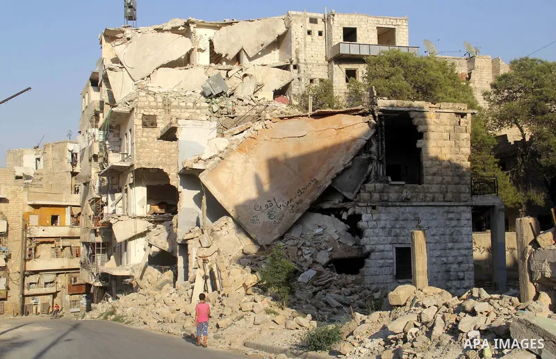 A Syrian boy walks past the rubble of buildings which destroyed by forces of Syria's President Bashar al-Assad, in a rebel-controlled area in the northern Syrian city of Aleppo, on August 31, 2015. Photo by Ameer al-Halb...