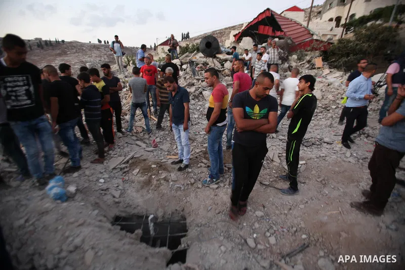 Palestinian men stand on the remains of house after Israeli bulldozers demolished during the Israeli operation, in the West Bank city of Jenin, on Sep. 01, 2015. Palestinian security officials said over 40 Israeli milita...
