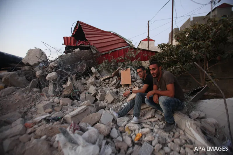 Palestinian men stand on the remains of house after Israeli bulldozers demolished during the Israeli operation, in the West Bank city of Jenin, on Sep. 01, 2015. Palestinian security officials said over 40 Israeli milita...