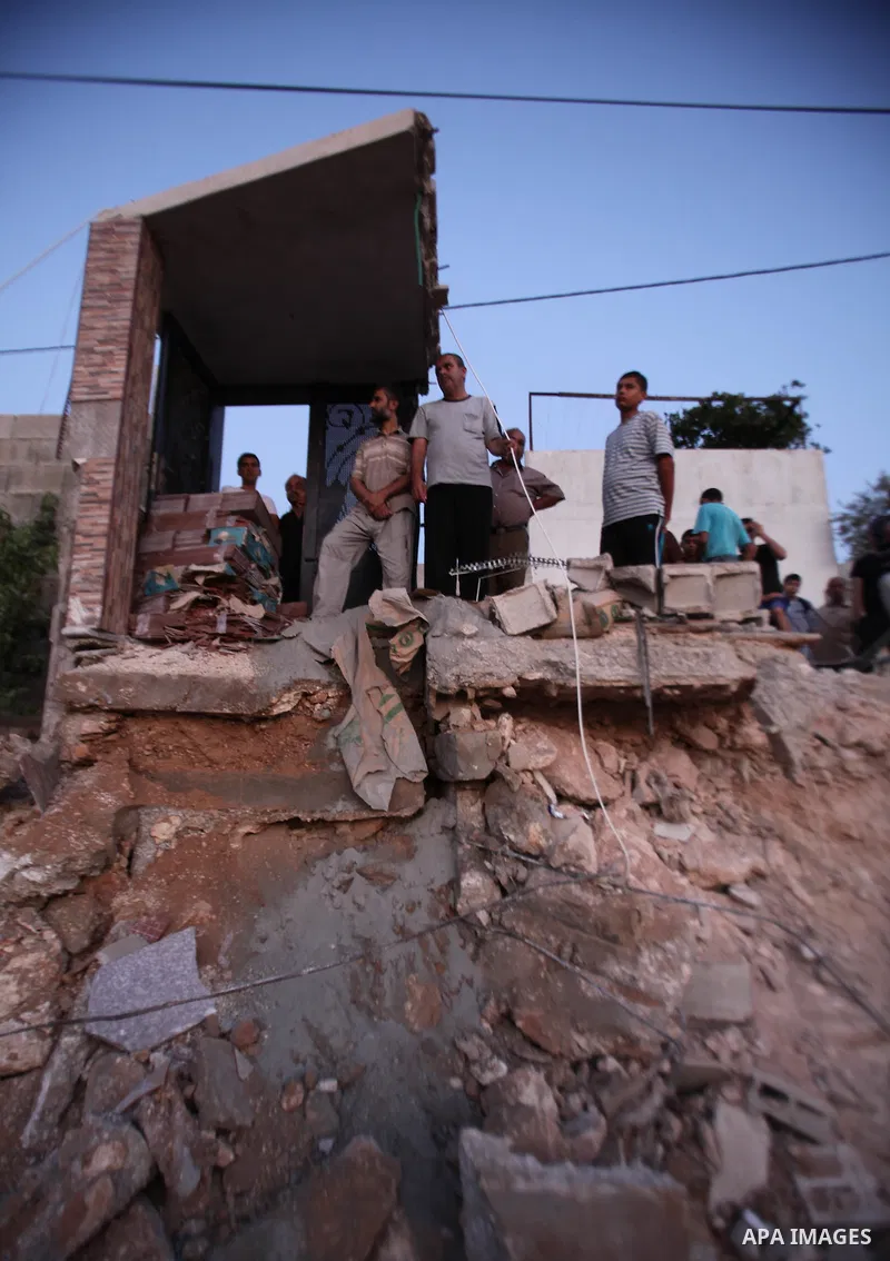Palestinian men stand on the remains of house after Israeli bulldozers demolished during the Israeli operation, in the West Bank city of Jenin, on Sep. 01, 2015. Palestinian security officials said over 40 Israeli milita...