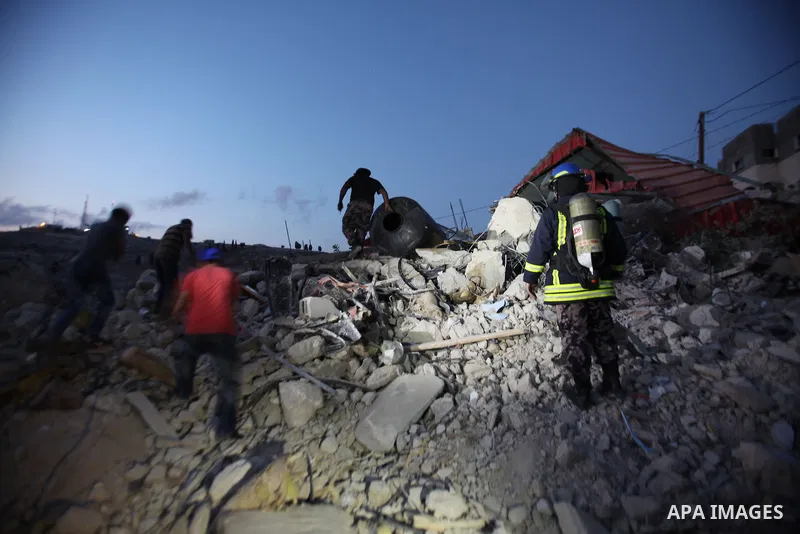 Palestinian men stand on the remains of house after Israeli bulldozers demolished during the Israeli operation, in the West Bank city of Jenin, on Sep. 01, 2015. Palestinian security officials said over 40 Israeli milita...