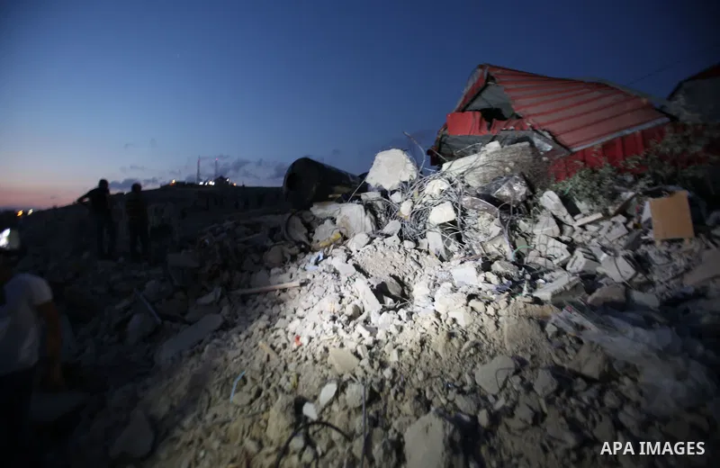 Palestinian men stand on the remains of house after Israeli bulldozers demolished during the Israeli operation, in the West Bank city of Jenin, on Sep. 01, 2015. Palestinian security officials said over 40 Israeli milita...