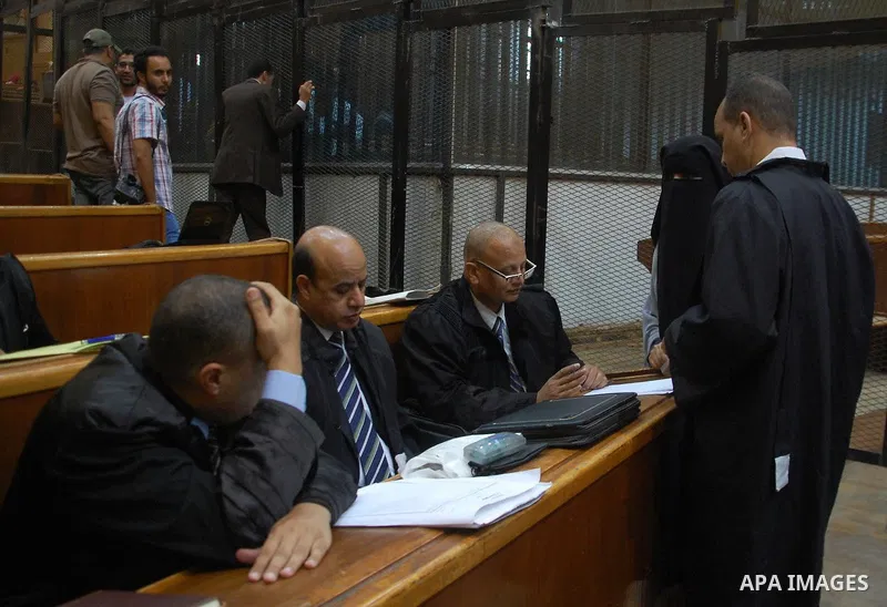 Egyptian Lawayers attend the trial of Egyptian Muslim Brotherhood defendant along with ousted Islamist president Mohamed Morsi (unseen) in Cairo on Sep. 01, 2015. Cairo criminal court resumed proceedings in the 'Qatar es...