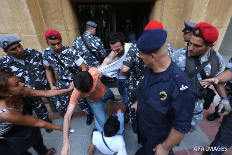 Lebanese activist clash with riot police outside the environment ministry in downtown Beirut on September 1, 2015 as Lebanese police started forcefully evacuating protesters who had occupied part of the building in a sur...