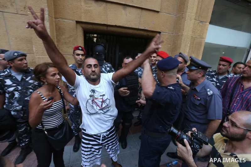 Lebanese activist clash with riot police outside the environment ministry in downtown Beirut on September 1, 2015 as Lebanese police started forcefully evacuating protesters who had occupied part of the building in a sur...