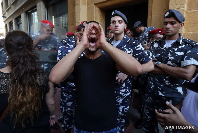 Lebanese activist clash with riot police outside the environment ministry in downtown Beirut on September 1, 2015 as Lebanese police started forcefully evacuating protesters who had occupied part of the building in a sur...
