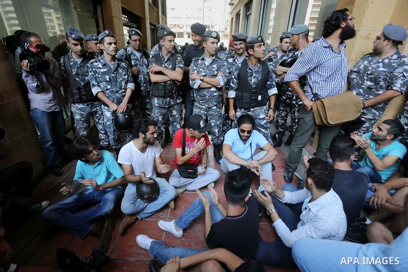 Lebanese activist clash with riot police outside the environment ministry in downtown Beirut on September 1, 2015 as Lebanese police started forcefully evacuating protesters who had occupied part of the building in a sur...