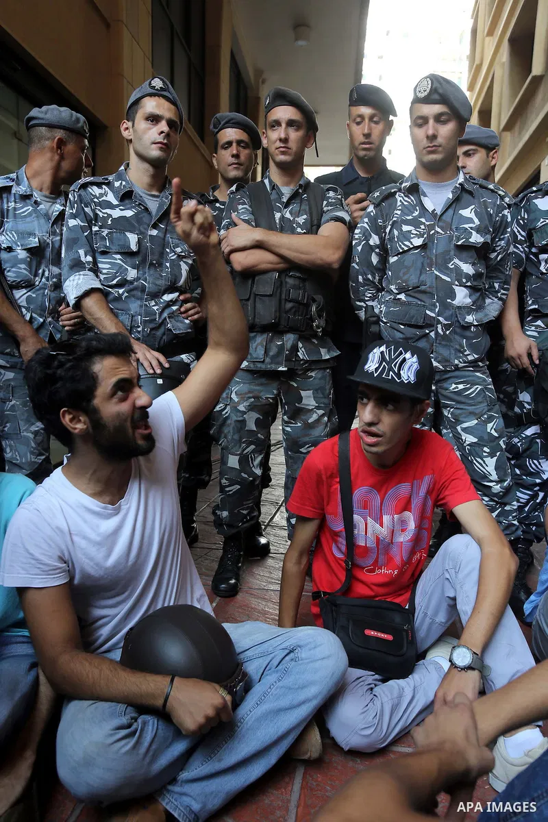 Lebanese activist clash with riot police outside the environment ministry in downtown Beirut on September 1, 2015 as Lebanese police started forcefully evacuating protesters who had occupied part of the building in a sur...