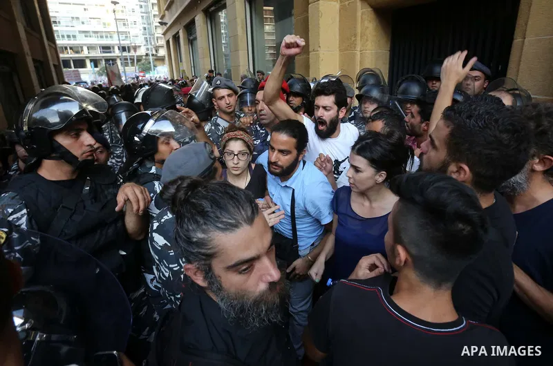 Lebanese activist clash with riot police outside the environment ministry in downtown Beirut on September 1, 2015 as Lebanese police started forcefully evacuating protesters who had occupied part of the building in a sur...