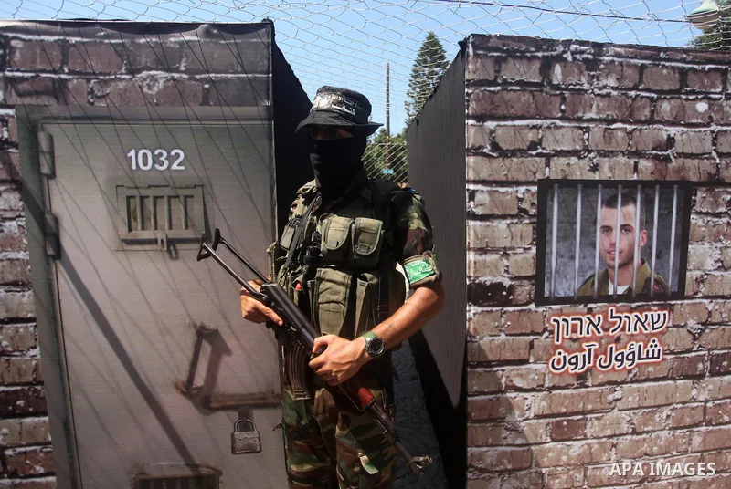 Palestinian militants of the Ezzedine al-Qassam Brigades, Hamas' armed wing, participate in the opening of the exhibition of the al-Qassam mock prisons, in Gaza city, on Sep. 02, 2015. Photo by Ashraf Amra