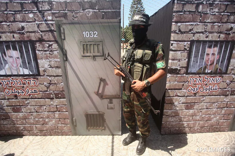 Palestinian militants of the Ezzedine al-Qassam Brigades, Hamas' armed wing, participate in the opening of the exhibition of the al-Qassam mock prisons, in Gaza city, on Sep. 02, 2015. Photo by Ashraf Amra