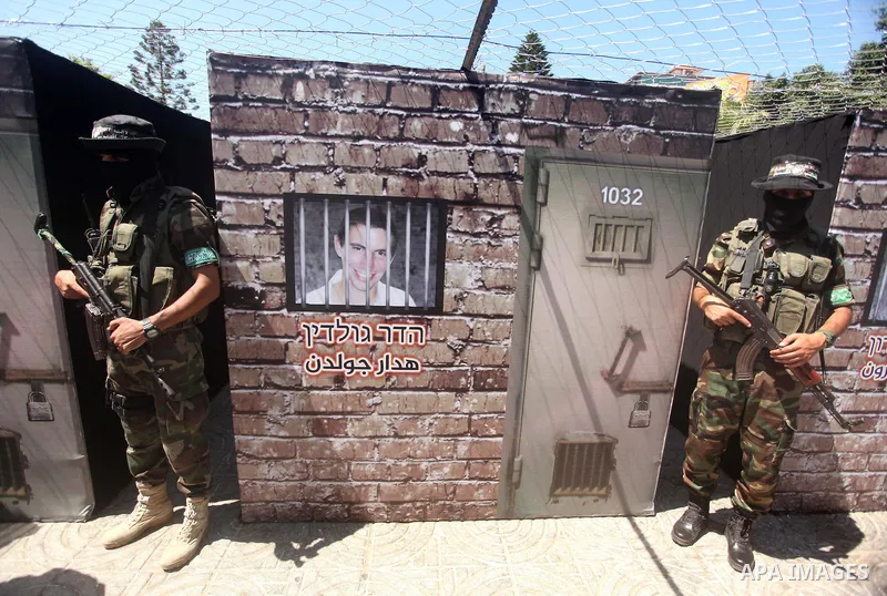 Palestinian militants of the Ezzedine al-Qassam Brigades, Hamas' armed wing, participate in the opening of the exhibition of the al-Qassam mock prisons, in Gaza city, on Sep. 02, 2015. Photo by Ashraf Amra