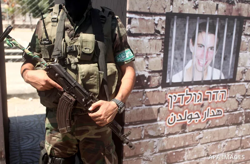 Palestinian militants of the Ezzedine al-Qassam Brigades, Hamas' armed wing, participate in the opening of the exhibition of the al-Qassam mock prisons, in Gaza city, on Sep. 02, 2015. Photo by Ashraf Amra