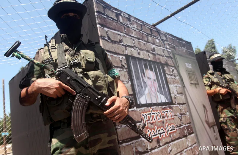 Palestinian militants of the Ezzedine al-Qassam Brigades, Hamas' armed wing, participate in the opening of the exhibition of the al-Qassam mock prisons, in Gaza city, on Sep. 02, 2015. Photo by Ashraf Amra