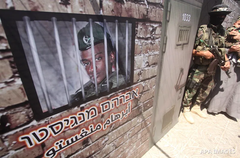 Palestinian militants of the Ezzedine al-Qassam Brigades, Hamas' armed wing, participate in the opening of the exhibition of the al-Qassam mock prisons, in Gaza city, on Sep. 02, 2015. Photo by Ashraf Amra