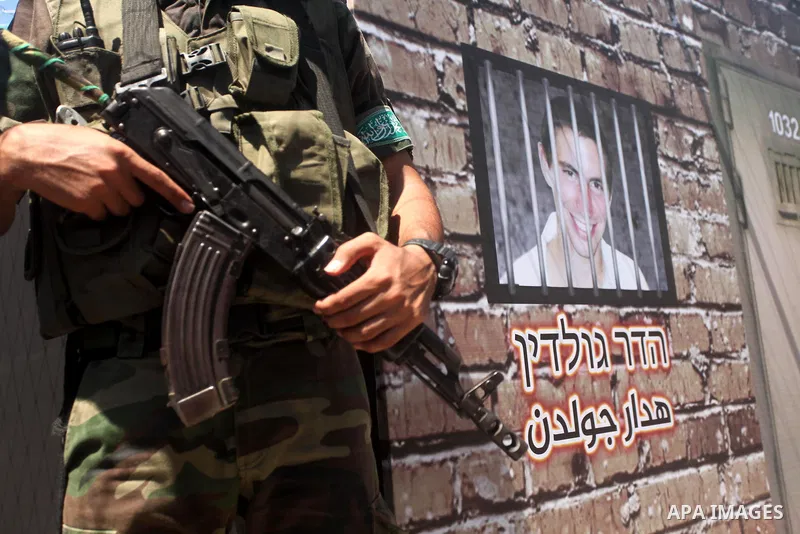 Palestinian militants of the Ezzedine al-Qassam Brigades, Hamas' armed wing, participate in the opening of the exhibition of the al-Qassam mock prisons, in Gaza city, on Sep. 02, 2015. Photo by Ashraf Amra
