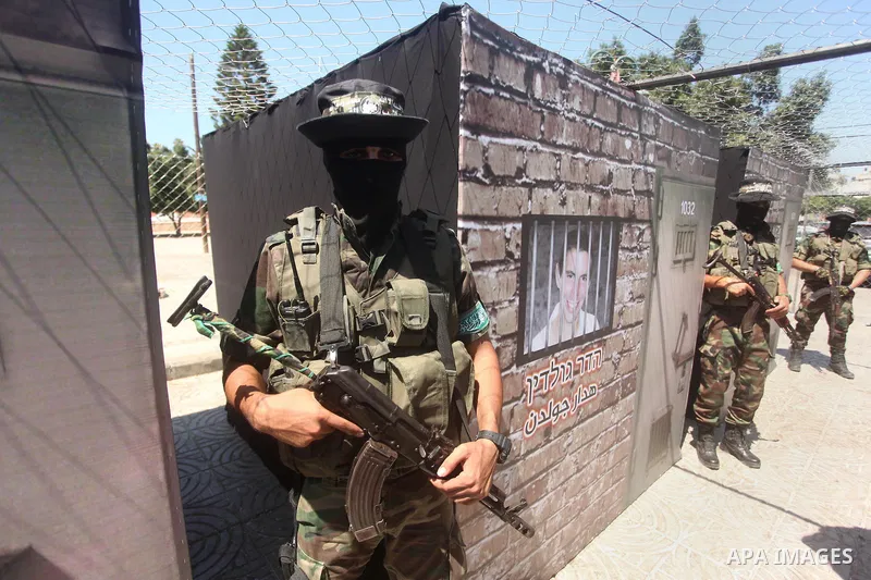 Palestinian militants of the Ezzedine al-Qassam Brigades, Hamas' armed wing, participate in the opening of the exhibition of the al-Qassam mock prisons, in Gaza city, on Sep. 02, 2015. Photo by Ashraf Amra