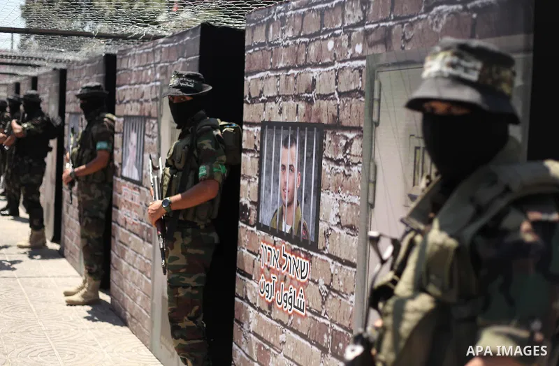 Palestinian militants of the Ezzedine al-Qassam Brigades, Hamas' armed wing, participate in the opening of the exhibition of the al-Qassam mock prisons, in Gaza city, on Sep. 02, 2015. Photo by Ashraf Amra