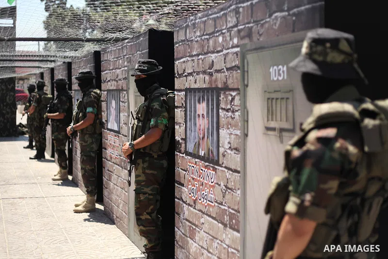 Palestinian militants of the Ezzedine al-Qassam Brigades, Hamas' armed wing, participate in the opening of the exhibition of the al-Qassam mock prisons, in Gaza city, on Sep. 02, 2015. Photo by Ashraf Amra