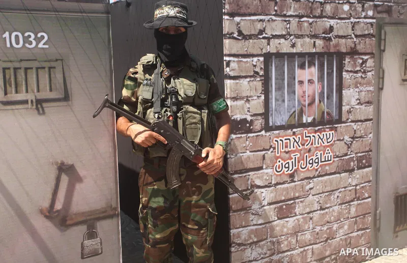 Palestinian militants of the Ezzedine al-Qassam Brigades, Hamas' armed wing, participate in the opening of the exhibition of the al-Qassam mock prisons, in Gaza city, on Sep. 02, 2015. Photo by Ashraf Amra
