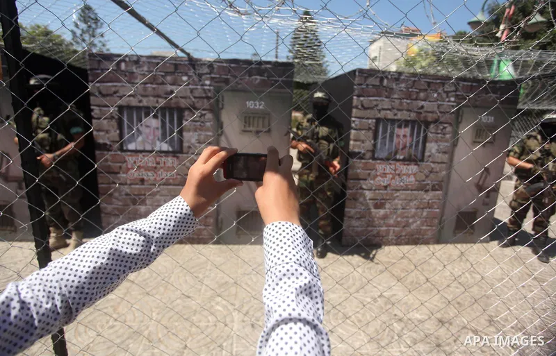 Palestinian militants of the Ezzedine al-Qassam Brigades, Hamas' armed wing, participate in the opening of the exhibition of the al-Qassam mock prisons, in Gaza city, on Sep. 02, 2015. Photo by Ashraf Amra