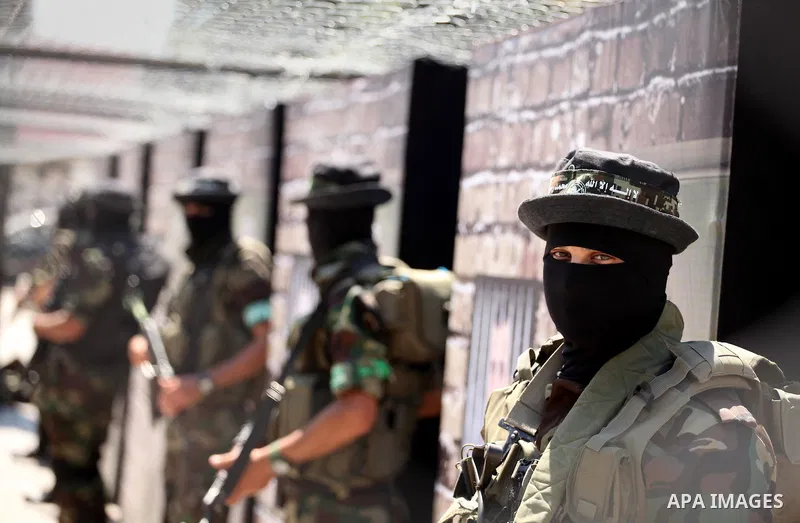 Palestinian militants of the Ezzedine al-Qassam Brigades, Hamas' armed wing, participate in the opening of the exhibition of the al-Qassam mock prisons, in Gaza city, on Sep. 02, 2015. Photo by Ashraf Amra