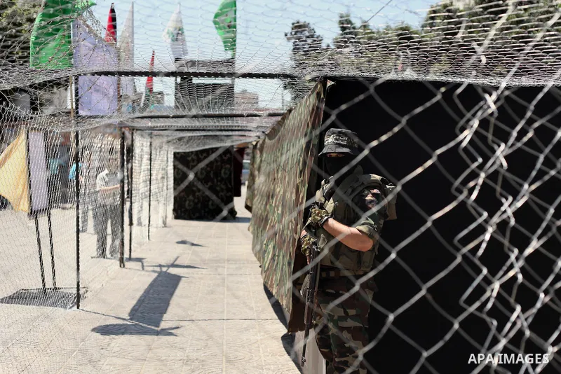 Palestinian militants of the Ezzedine al-Qassam Brigades, Hamas' armed wing, participate in the opening of the exhibition of the al-Qassam mock prisons, in Gaza city, on Sep. 02, 2015. Photo by Ashraf Amra