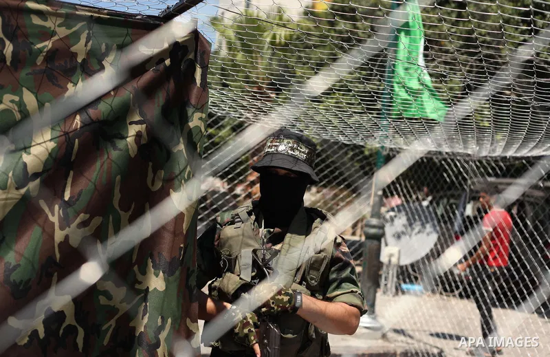 Palestinian militants of the Ezzedine al-Qassam Brigades, Hamas' armed wing, participate in the opening of the exhibition of the al-Qassam mock prisons, in Gaza city, on Sep. 02, 2015. Photo by Ashraf Amra