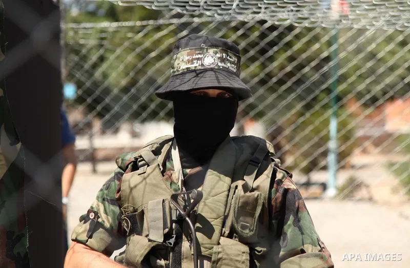 Palestinian militants of the Ezzedine al-Qassam Brigades, Hamas' armed wing, participate in the opening of the exhibition of the al-Qassam mock prisons, in Gaza city, on Sep. 02, 2015. Photo by Ashraf Amra
