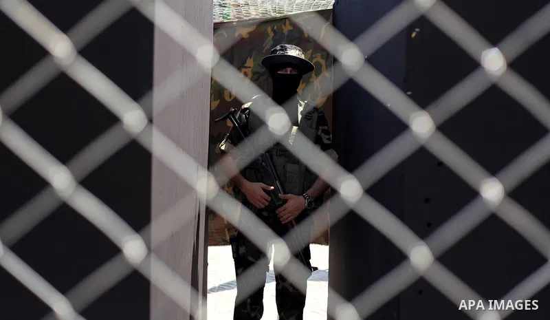 Palestinian militants of the Ezzedine al-Qassam Brigades, Hamas' armed wing, participate in the opening of the exhibition of the al-Qassam mock prisons, in Gaza city, on Sep. 02, 2015. Photo by Ashraf Amra