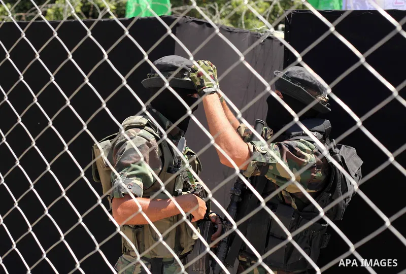 Palestinian militants of the Ezzedine al-Qassam Brigades, Hamas' armed wing, participate in the opening of the exhibition of the al-Qassam mock prisons, in Gaza city, on Sep. 02, 2015. Photo by Ashraf Amra