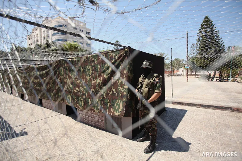 Palestinian militants of the Ezzedine al-Qassam Brigades, Hamas' armed wing, participate in the opening of the exhibition of the al-Qassam mock prisons, in Gaza city, on Sep. 02, 2015. Photo by Ashraf Amra