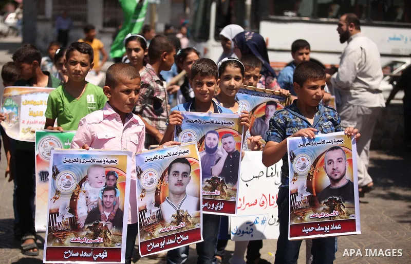 Palestinians watch the opening of the exhibition of the al-Qassam mock prisons, in Gaza city, on Sep. 02, 2015 mock. Photo by Ashraf Amra