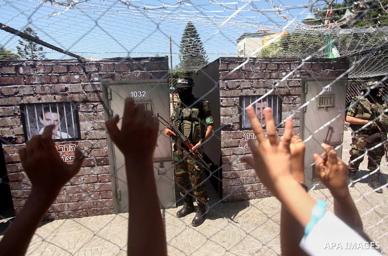 Palestinian militants of the Ezzedine al-Qassam Brigades, Hamas' armed wing, participate in the opening of the exhibition of the al-Qassam mock prisons, in Gaza city, on Sep. 02, 2015. Photo by Ashraf Amra