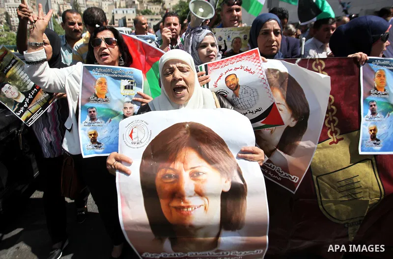 Palestinian protesters hold posters during a protest to show soldarity with prisoners, in the West Bank city of Nablus, on Sep. 03, 2015. Photo by Nedal Eshtayah