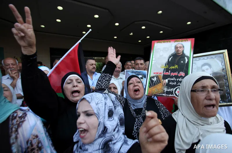 Palestinian protesters hold posters during a protest to show soldarity with prisoners, in the West Bank city of Nablus, on Sep. 03, 2015. Photo by Nedal Eshtayah