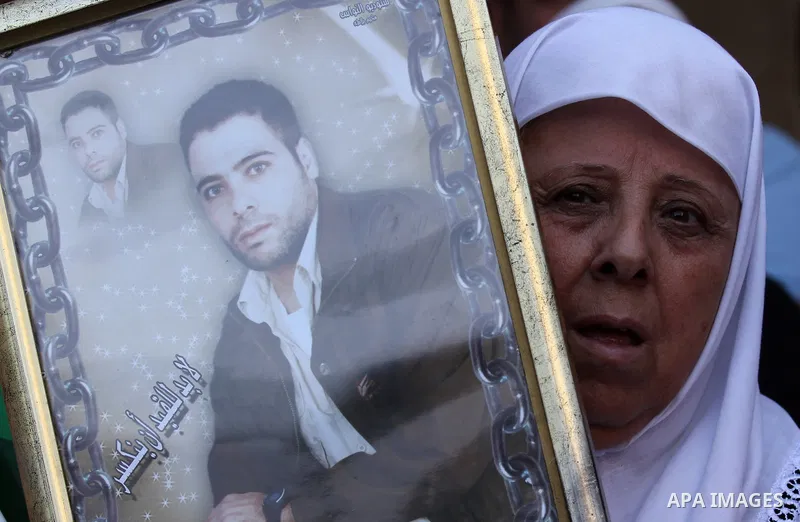 Palestinian protesters hold posters during a protest to show soldarity with prisoners, in the West Bank city of Nablus, on Sep. 03, 2015. Photo by Nedal Eshtayah