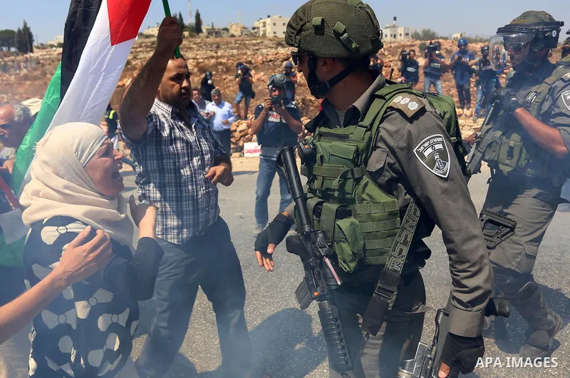A Palestinian woman argues with an Israeli border policeman during a protest against Jewish settlements in the West Bank village of Nabi Saleh, near Ramallah September 4, 2015. Photo by Shadi Hatem