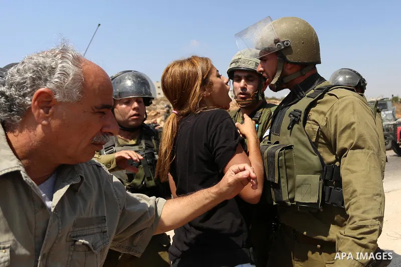 A Palestinian woman argues with an Israeli border policeman during a protest against Jewish settlements in the West Bank village of Nabi Saleh, near Ramallah September 4, 2015. Photo by Shadi Hatem