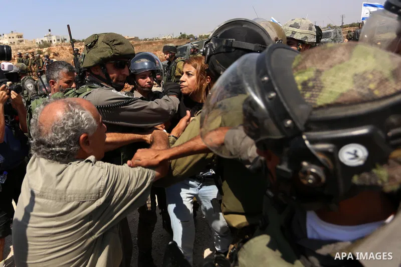 A Palestinian woman argues with an Israeli border policeman during a protest against Jewish settlements in the West Bank village of Nabi Saleh, near Ramallah September 4, 2015. Photo by Shadi Hatem