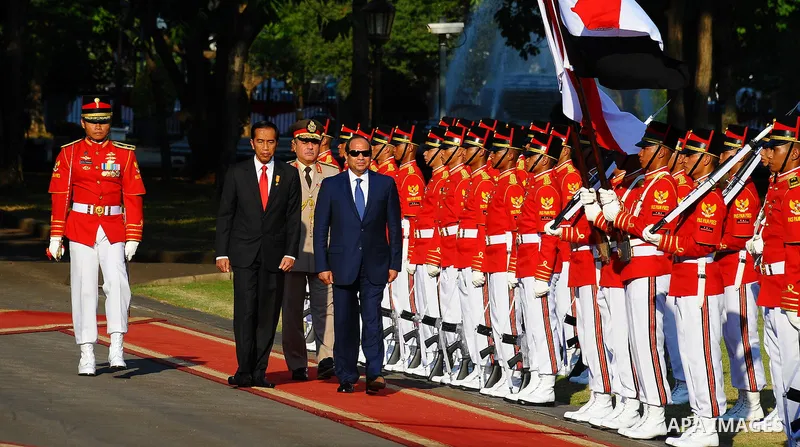 Egypt's President Abdel Fattah al-Sisi walks with Indonesia's President Joko Widodo as they review the honour guard at the presidential palace in Jakarta on September 4, 2015. Al-Sisi, who arrived from Beijing, is on the...