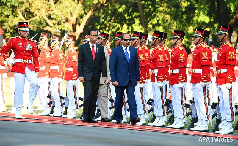 Egypt's President Abdel Fattah al-Sisi walks with Indonesia's President Joko Widodo as they review the honour guard at the presidential palace in Jakarta on September 4, 2015. Al-Sisi, who arrived from Beijing, is on the...